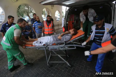 A Palestinian man is wheeled from the emergency ward at Al-Shifa hospital after he was injured during an airstrike in the Gaza city on Aug. 24, 2014. Egypt called on Israel and the Palestinians on Saturday to halt hostil...