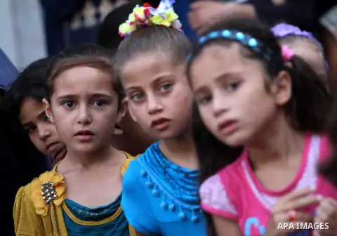 Palestinian children enjoy in games in the courtyard of a UN school, that shelters hundreds of families after fighting between Israel and Hamas broke out July 8, during a morning activity on the day that schools across G...