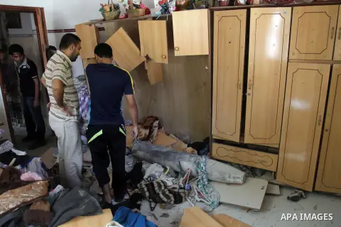 Palestinian men inspect the rubble of their house following an Israeli air strike in Deir al-Balah in the central Gaza strip on August 24, 2014. Egypt called on Israel and the Palestinians on Saturday to halt hostilities...