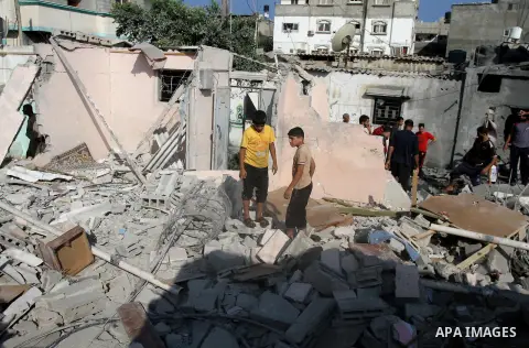 Palestinian men inspect the rubble of their house following an Israeli air strike in Deir al-Balah in the central Gaza strip on August 24, 2014. Egypt called on Israel and the Palestinians on Saturday to halt hostilities...
