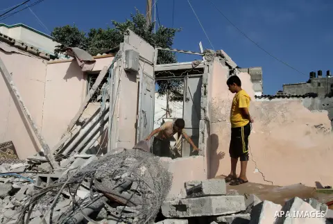 Palestinian men inspect the rubble of their house following an Israeli air strike in Deir al-Balah in the central Gaza strip on August 24, 2014. Egypt called on Israel and the Palestinians on Saturday to halt hostilities...
