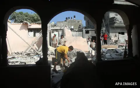 Palestinian men inspect the rubble of their house following an Israeli air strike in Deir al-Balah in the central Gaza strip on August 24, 2014. Egypt called on Israel and the Palestinians on Saturday to halt hostilities...