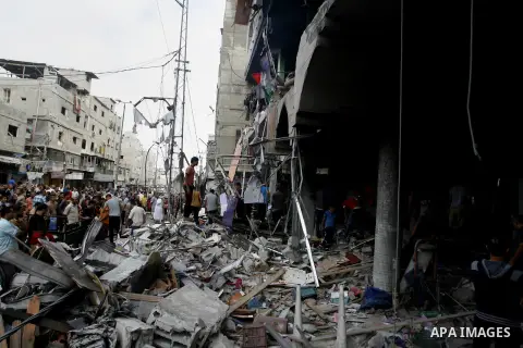 Palestinians look at the remains of a commercial center, which witnesses said was hit by an Israeli air strike on Saturday, in Rafah in the southern Gaza Strip August 24, 2014. Egypt called on Israel and the Palestinians...