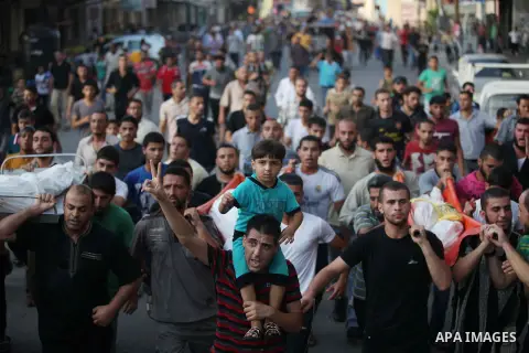 Mourners carry the body of one of four Palestinians from the Juda family, whom medics said were killed in an Israeli air strike, during their funeral in Jabaliya in the northern Gaza Strip August 24, 2014. Israeli Prime...