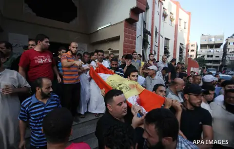 Mourners carry the body of one of four Palestinians from the Juda family, whom medics said were killed in an Israeli air strike, during their funeral in Jabaliya in the northern Gaza Strip August 24, 2014. Israeli Prime...