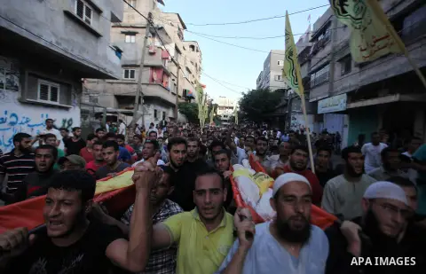 Mourners carry the body of one of four Palestinians from the Juda family, whom medics said were killed in an Israeli air strike, during their funeral in Jabaliya in the northern Gaza Strip August 24, 2014. Israeli Prime...