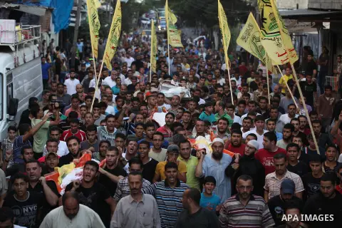 Mourners carry the body of one of four Palestinians from the Juda family, whom medics said were killed in an Israeli air strike, during their funeral in Jabaliya in the northern Gaza Strip August 24, 2014. Israeli Prime...