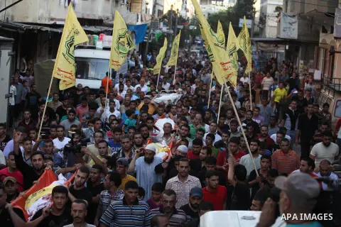 Mourners carry the body of one of four Palestinians from the Juda family, whom medics said were killed in an Israeli air strike, during their funeral in Jabaliya in the northern Gaza Strip August 24, 2014. Israeli Prime...