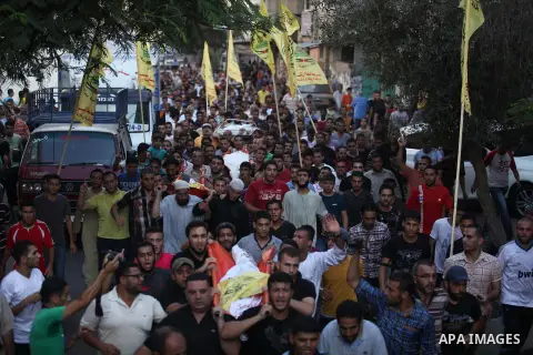 Mourners carry the body of one of four Palestinians from the Juda family, whom medics said were killed in an Israeli air strike, during their funeral in Jabaliya in the northern Gaza Strip August 24, 2014. Israeli Prime...