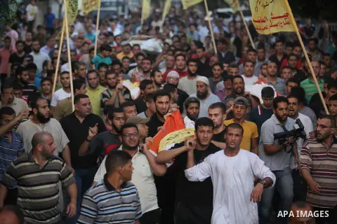 Mourners carry the body of one of four Palestinians from the Juda family, whom medics said were killed in an Israeli air strike, during their funeral in Jabaliya in the northern Gaza Strip August 24, 2014. Israeli Prime...