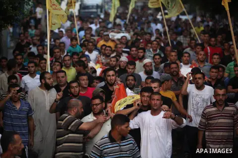 Mourners carry the body of one of four Palestinians from the Juda family, whom medics said were killed in an Israeli air strike, during their funeral in Jabaliya in the northern Gaza Strip August 24, 2014. Israeli Prime...