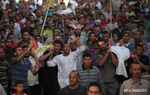 Mourners carry the body of one of four Palestinians from the Juda family, whom medics said were killed in an Israeli air strike, during their funeral in Jabaliya in the northern Gaza Strip August 24, 2014. Israeli Prime...