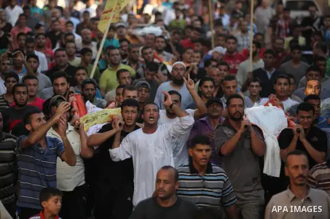 Mourners carry the body of one of four Palestinians from the Juda family, whom medics said were killed in an Israeli air strike, during their funeral in Jabaliya in the northern Gaza Strip August 24, 2014. Israeli Prime...