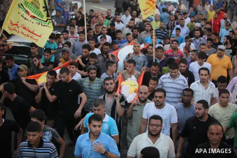 Mourners carry the body of one of four Palestinians from the Juda family, whom medics said were killed in an Israeli air strike, during their funeral in Jabaliya in the northern Gaza Strip August 24, 2014. Israeli Prime...