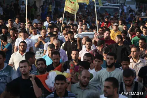 Mourners carry the body of one of four Palestinians from the Juda family, whom medics said were killed in an Israeli air strike, during their funeral in Jabaliya in the northern Gaza Strip August 24, 2014. Israeli Prime...