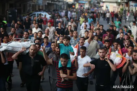 Mourners carry the body of one of four Palestinians from the Juda family, whom medics said were killed in an Israeli air strike, during their funeral in Jabaliya in the northern Gaza Strip August 24, 2014. Israeli Prime...
