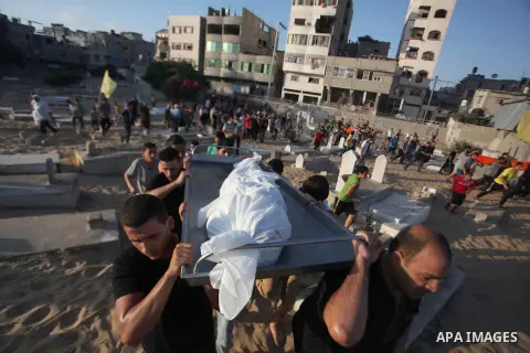 Mourners carry the body of one of four Palestinians from the Juda family, whom medics said were killed in an Israeli air strike, during their funeral in Jabaliya in the northern Gaza Strip August 24, 2014. Israeli Prime...