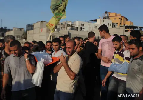 Mourners carry the body of one of four Palestinians from the Juda family, whom medics said were killed in an Israeli air strike, during their funeral in Jabaliya in the northern Gaza Strip August 24, 2014. Israeli Prime...