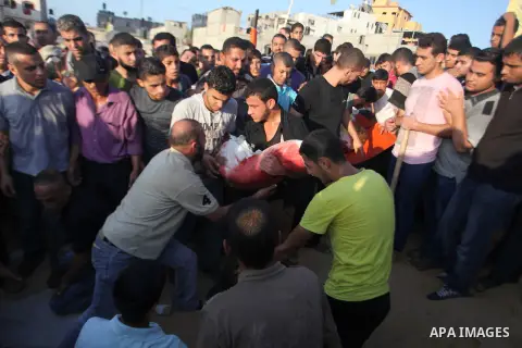 Mourners carry the body of one of four Palestinians from the Juda family, whom medics said were killed in an Israeli air strike, during their funeral in Jabaliya in the northern Gaza Strip August 24, 2014. Israeli Prime...