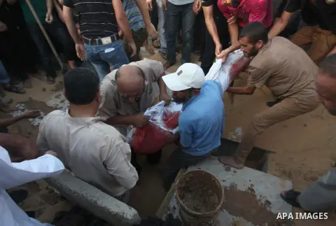 Mourners carry the body of one of four Palestinians from the Juda family, whom medics said were killed in an Israeli air strike, during their funeral in Jabaliya in the northern Gaza Strip August 24, 2014. Israeli Prime...