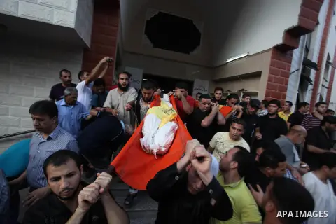 Mourners carry the body of one of four Palestinians from the Juda family, whom medics said were killed in an Israeli air strike, during their funeral in Jabaliya in the northern Gaza Strip August 24, 2014. Israeli Prime...