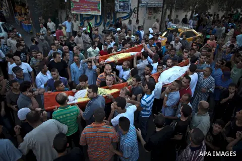 Mourners carry the body of one of four Palestinians from the Juda family, whom medics said were killed in an Israeli air strike, during their funeral in Jabaliya in the northern Gaza Strip August 24, 2014. Israeli Prime...