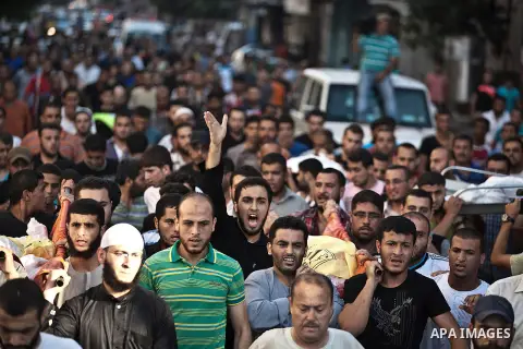 Mourners carry the body of one of four Palestinians from the Juda family, whom medics said were killed in an Israeli air strike, during their funeral in Jabaliya in the northern Gaza Strip August 24, 2014. Israeli Prime...