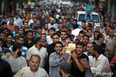 Mourners carry the body of one of four Palestinians from the Juda family, whom medics said were killed in an Israeli air strike, during their funeral in Jabaliya in the northern Gaza Strip August 24, 2014. Israeli Prime...