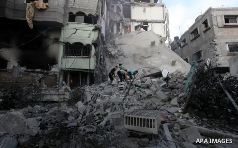 Palestinians inspect Al-Rahma Charity Association targeted in an Israeli air strike in Khan Younis in the southern Gaza strip on August 25, 2014. An Israeli air raid in Gaza left two Palestinians dead overnight, taking t...