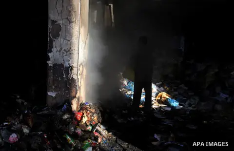 Palestinians inspect Al-Rahma Charity Association targeted in an Israeli air strike in Khan Younis in the southern Gaza strip on August 25, 2014. An Israeli air raid in Gaza left two Palestinians dead overnight, taking t...