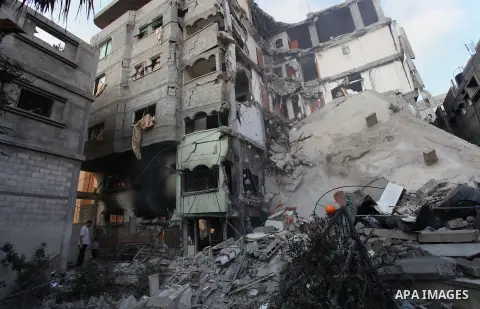 Palestinians inspect Al-Rahma Charity Association targeted in an Israeli air strike in Khan Younis in the southern Gaza strip on August 25, 2014. An Israeli air raid in Gaza left two Palestinians dead overnight, taking t...
