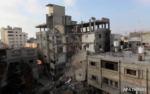 Palestinians inspect Al-Rahma Charity Association targeted in an Israeli air strike in Khan Younis in the southern Gaza strip on August 25, 2014. An Israeli air raid in Gaza left two Palestinians dead overnight, taking t...