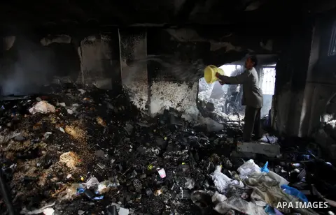 Palestinians inspect Al-Rahma Charity Association targeted in an Israeli air strike in Khan Younis in the southern Gaza strip on August 25, 2014. An Israeli air raid in Gaza left two Palestinians dead overnight, taking t...