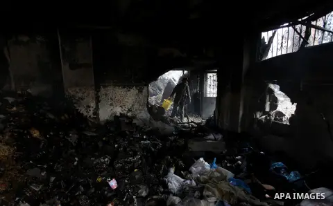 Palestinians inspect Al-Rahma Charity Association targeted in an Israeli air strike in Khan Younis in the southern Gaza strip on August 25, 2014. An Israeli air raid in Gaza left two Palestinians dead overnight, taking t...