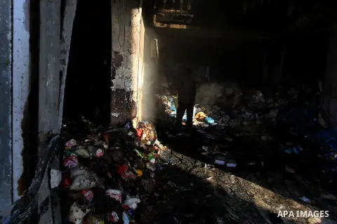 Palestinians inspect Al-Rahma Charity Association targeted in an Israeli air strike in Khan Younis in the southern Gaza strip on August 25, 2014. An Israeli air raid in Gaza left two Palestinians dead overnight, taking t...