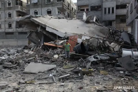 A Palestinian man inspects a building of al-Ghul's house after it was targeted in an Israeli airstrike in Gaza City on August 25, 2014. One of Sunday's air strikes killed Hamas financial official Mohammed al-Ghul as he w...