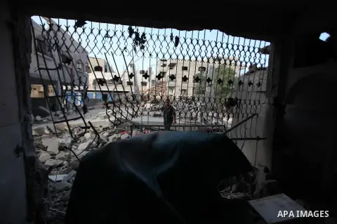 A Palestinian man inspects a building of al-Ghul's house after it was targeted in an Israeli airstrike in Gaza City on August 25, 2014. One of Sunday's air strikes killed Hamas financial official Mohammed al-Ghul as he w...