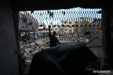 A Palestinian man inspects a building of al-Ghul's house after it was targeted in an Israeli airstrike in Gaza City on August 25, 2014. One of Sunday's air strikes killed Hamas financial official Mohammed al-Ghul as he w...