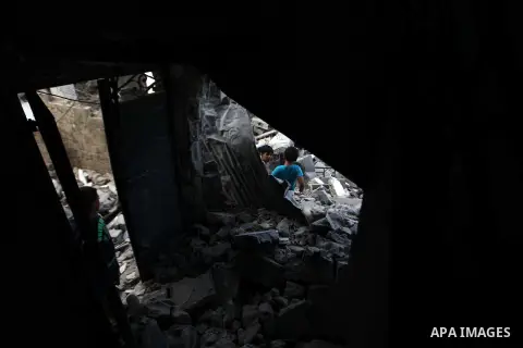 A Palestinian man inspects a building of al-Ghul's house after it was targeted in an Israeli airstrike in Gaza City on August 25, 2014. One of Sunday's air strikes killed Hamas financial official Mohammed al-Ghul as he w...