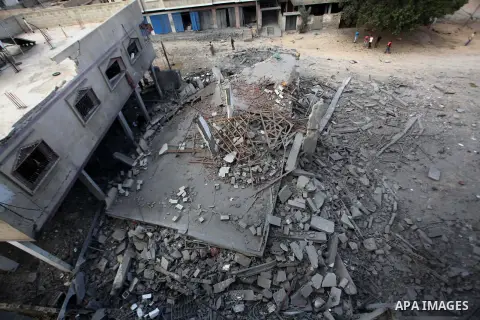 A Palestinian man inspects a building of al-Ghul's house after it was targeted in an Israeli airstrike in Gaza City on August 25, 2014. One of Sunday's air strikes killed Hamas financial official Mohammed al-Ghul as he w...