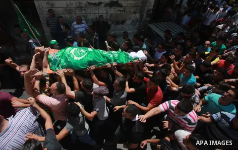 Palestinians carry the body of Hassan Ashour, a Palestinian teenager who died of his injuries, during his funeral on August 25, 2014 in the West Bank city of Nablus. Hassan Ashur was shot in the abdomen with live fire as...