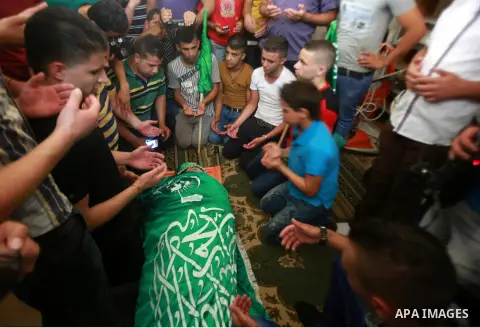 Palestinians carry the body of Hassan Ashour, a Palestinian teenager who died of his injuries, during his funeral on August 25, 2014 in the West Bank city of Nablus. Hassan Ashur was shot in the abdomen with live fire as...