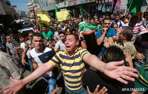 Palestinians carry the body of Hassan Ashour, a Palestinian teenager who died of his injuries, during his funeral on August 25, 2014 in the West Bank city of Nablus. Hassan Ashur was shot in the abdomen with live fire as...