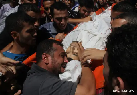 The father of Palestinian Osama Shabbir mourns during his funeral in Jabaliya in the northern Gaza Strip August 25, 2014. Israel's Prime Minister Benjamin Netanyahu warned Palestinian civilians on Sunday to leave immedia...