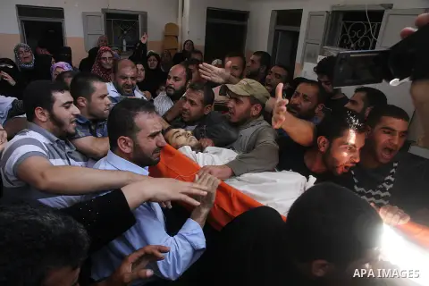 Mourners carry the body of of Palestinian Osama Shabbir, whom medics said was killed in an Israeli air strike, during his funeral in Jabaliya in the northern Gaza Strip August 25, 2014. Israel's Prime Minister Benjamin N...