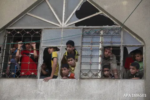 Palestinians mourn over the bodies of Basim Hijazi 36, his brother Ahmed, 26, and a friend Mohamad al-Dali who were killed when their car was hit by an Israeli air strike during their funeral in Gaza City on August 25, 2...