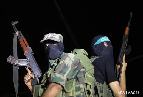 Palestinian Hamas militants hold their weapons as they celebrate with people what they said was a victory over Israel, following a ceasefire in Gaza City August 26, 2014. A ceasefire agreement between Israel and the Pale...