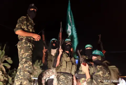 Palestinian Hamas militants hold their weapons as they celebrate with people what they said was a victory over Israel, following a ceasefire in Gaza City August 26, 2014. A ceasefire agreement between Israel and the Pale...