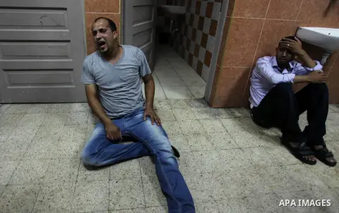 Palestinian relatives mourn on the body of Palestinian man, whom medics said was killed in an Israeli air strike, during his funeral in Khan Younis in the southern Gaza Strip August 26, 2014. Palestinian President Mahmou...
