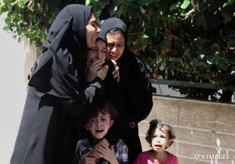 Relatives of two Palestinian children Mohammed and Omar al-Brim, who witnesses said were killed in an Israeli air strike before a ceasefire was declared, mourn during their funeral in Khan Younis in the southern Gaza Str...